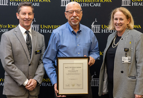 Garry Buetter is presented a Wall of Scholarship award for his citation classic