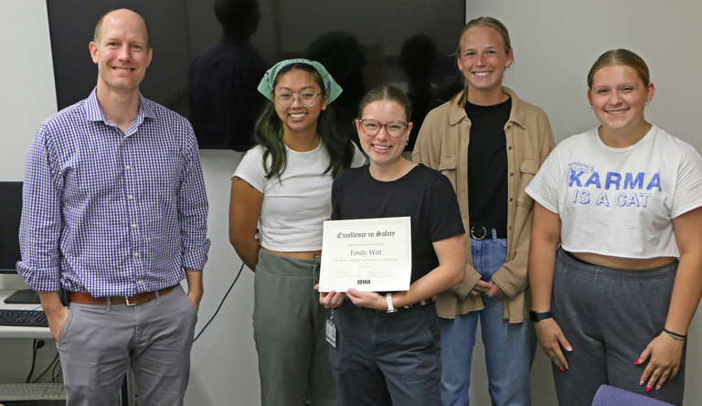 Photo of Byrne lab and Emily with safety award